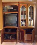 Entertainment center with sliding shelf for TV and sliding shelves on bottom.  Made up of two sections, each measuring 30Wx76Tx20Deep. They match the other two sections in Lot 29. Plenty of storage space for DVD's, books and players of all kinds.  Contents not included in this lot. In very good condition.