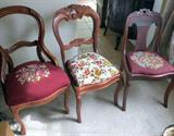 Three vintage carved wood chairs, two with needlepoint seat covers, one has fabric covered seat, the higher back of the three has loose joint