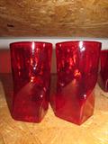 A set of six very cool ruby red vintage tumblers. Each is 5.5" high, and each is in perfect condition. The base of these great glasses is square, and that swirls up to the round top. Check out the next lot for 6 more and set your holiday table in style!