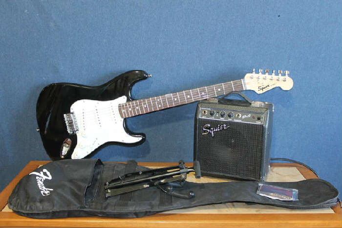 Terrific Fender Squire Strat Electric Guitar in Black with Pearlized Accents, a SP 10 Amp, Portable Music Stand, and Softside Black Nylon Carrying Case