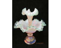 Fenton iridized pink carnival glass epergne.  The piece has a single horn and a ruffled edge.  It measures approx. 9" w X 10" h and is signed "Bill Fenton" and has original sticker.