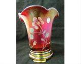 Fenton 100th Anniversary Founder's Vase.  It is ruby stretch glass and has an amber colored base.  The piece is marked "100th Anniversary Founder's Vase - Frank L Fenton - Founder - 1905" and is signed "Frank M Fenton and George W Fenton.  The piece is also signed by artist "D Robinson".