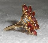 This is a beautiful 14K gold ring with 9 root beer colored gemstones approximately size 8 marked inside the band 14K on one side and the other side is marked with a J inside a triangle and 1K. It weighs 3.01 grams