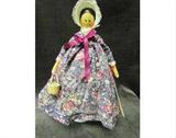 "Penny Wooden Doll" - this is the name give to jointed and pegged dolls of hard wood which became some of the first "play" dolls in America.  This reproduction has tongue and groove joints, hand painted features, and is signed and dated by the artist.  "Harmony" is signed by "Nancy Castendyle" 1995.  There is also another number - 1629.  Harmony is wearing a floral print dress, bloomers, and a bonnet.  She is carrying a woven basket .
