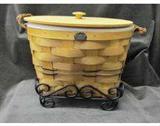 Peterboro large basket with wooden cake riser, divider, and wooden lid.  Also includes wrought iron holder from the Wrought Iron Collection. The basket measures approx. 15 in. in diameter x 10 inches tall