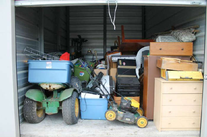 A loaded storage unit containing:  John Deere 112 riding mower(great restoration piece), push mower, Weider exercise station, furniture (coffee table, dresser), Quasar speakers, HP printer, Calphalon cookware, vacuum cleaners, toys, and more.