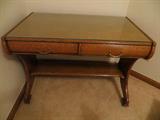 Beautiful Antique Oak Desk/Library Table with 2 Drawers, Carved Details on Sides,has been refinished with protective glass top, in very good condition, on casters. Dimensions: 29.5 x 40 x 25