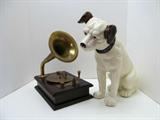 Really cool RCA mascot "Nipper" listening to "His Master's Voice". This depicts what RCA used on many of the old record labels. The musical box plays a few cords then stops until wound again. The dog is approx. 12h.