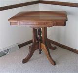 Awesome vintage solid wood table with a 4-leg base which has a turned center piece. Approx. 30w x 20d x 26h.
