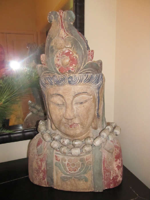 This is a truly remarkable antique bust. It is wood, and it is heavy. It is 27" high and 18" wide at its base. Much of its original paint has worn off giving it all the patina it needs. And, it features an amazing wood bead necklace.