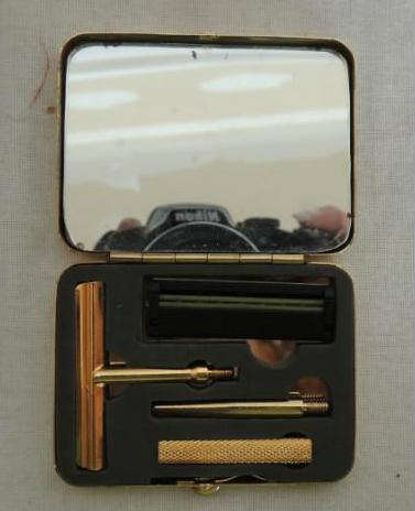 Vintage Shaving Set - Gold plated travel shaving set, ever been used. Razor and mirror included. Wood shelf with 4 hooks. Platfom measuring 5Hx18 1/2W. Ceramic hand painted glazed vase picture frame(measurements) 8Hx6W. Easel Grandmas picture. "Grandmas are just antique little girls" Easel 4 1/2H Picture 3 1/2Hx5W. Vintage Last supper in frame, frame broken verry delicate. 8Hx10W. Baby girl frame white pressed wood. Glass liquor bottle with rubber cork.