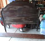 Antique - Head board, foot board, 2 unfinished rails, partially stained.  Metal wheels on both ends. Dirt dried in stain appears. Measurements 54Hx56W(head) 56 1/2Wx27H(foot) 72L(rails) 50L(box board) Hand carved design, one piece has cracked and holding on from vintage carpenter nail.