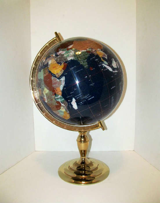 Beautiful desk top and moving glass-made world globe on a polished brass base. The various colors used gives this globe a mosaic look. Very classy looking. Approx. 20h x 13 in dia.