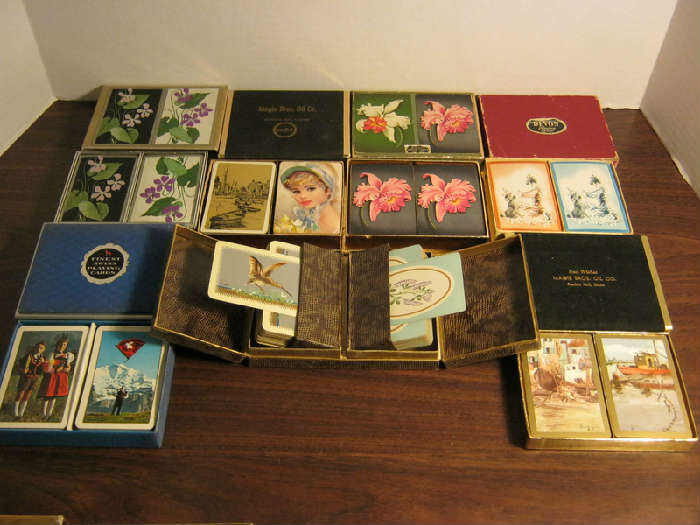 Vintage Playing Cards - Seven Double Packs: Titanium Pigmented Playing Cards - opens from the middle and lifts the cards up for easy access; "Berner Tracht" and "Fahenschwinger" - Finest Swiss Playing Cards; Illustrator signed (Sea Port scenes) - Best Wishes Magie Bros. Oil Co. Franklin Park, Illinois; Floral - Congress Playing Cards - Cel-U-Tone Finish; Orange and Blue Playing Cards with Dog and Lady - Devon Playing Cards; Harbor scene and pretty lady with hat - Magie Bros. Oil Co. Franklin Park, Illinois; Flora - Duratone Plastic Coated Playing Cards.