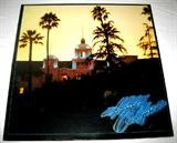 "Hotel California" The Eagles. Good condition. No visible scratches. Side One: Hotel California, New Kid in Town, Life in the Fast Lane, Wasted Time. Side Two: Wasted tine (Reprise), Victim of Love, Pretty Maids All in a Row, Try and Love Again, The Last Resort/