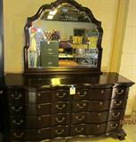 Broughton Hall LTD. Solid Mahogany Dresser with Sculpted Beveled Glass Mirror.  69" W 36" T 20" D mirror is 33" W 41" T This lot is for one piece of a five piece set in this auction. All very well cared for and very beautiful. Look closely at the quality, even the drawer bottoms. This is really Magnificent furniture. Matches Lot #'s 22, 23, 35, 36.   See Pictures for details and condition.
