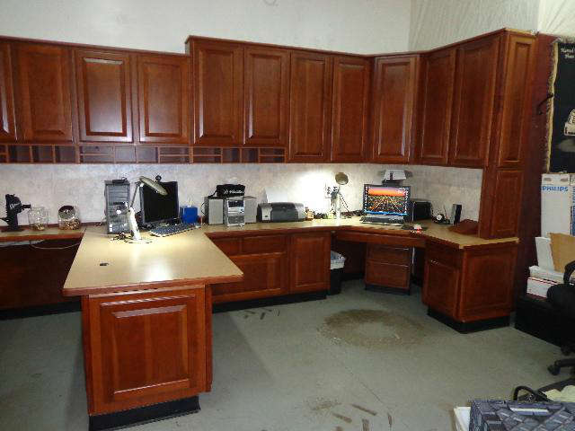U shaped office run of Merilat brand cabinets with solid cherry doors and fronts in the color known as Paprika. Bottom Cabinets: Left side of the U has two small drawers (13.75D x 16.25W x 5.5T), one door (20.5D x 13.25W x 22.5T) and one file drawer (18.25D x 34.25W x 16T). The right side of the U consists of one small drawer (16.25W x 20.5D x 5.5T) and a file drawer (16.25W x 16T). The center of the U shape has two small drawers (13.75D x 16.25W x 5.5T), one door (20.5D x 16.25W x 22.5T) and one file drawer (18.25D x 34.25W x 16T). Top cabinets: One set measures 36W x 36T, two sets measure 36W x 42T and there is a corner cabinet that measures 42T. There are two sections of countertop with the left side measuring 76 x 67 x 37 and the right side measuring 67 x 66 x 26. This set also includes one under cabinet cubby (36W) and there is an extra two drawer cabinet that is sitting underneath the corner desk space. It has been cut to fit in this space without interfering with the drawer (34.