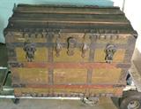 This is a VERY nice circa 1890 Steamer trunk. The seller tells me that her Grandmother used this trunk when she immigrated to the United States from Ireland in 1890. The trunk measures 36.5" x 25" x 22.5" and is very heavy made of wood, tin and wrought iron. The contents are also included which include an old chenille bed spread in good condition several religious documents and framed religious photos. Please see photos.
