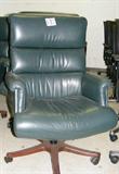 Verta traditional style green leather high back executive task chair with a wood base and rolled arms. Excellent condition. Right wall front section.