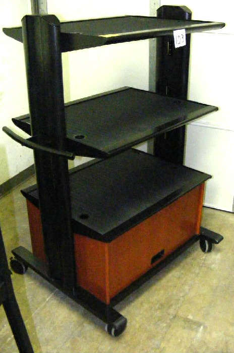 Mobile Audio/Visual media cart with 3 shelves and lower compartment. Good condition. Approx. 36w x 32d x 55h. Left dock, left wall.