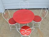 Vintage twisted heart wrought iron and wood, ice cream parlor table and chairs, has been painted so cannot tell if wood is oak, appear to be in good condition, table approx. 30"h x 30"dia.