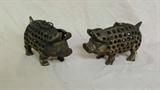 Vintage cast iron pig candle holders. Very unique pieces. Measures 7 H x 10 D.