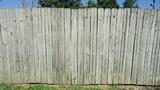 Privacy Fencing - There ninety seven fence panels. Each panels consists of fifteen side by side pressure treated wood boards. The panels are 6 ft high x 8 ft wide. Total length is 776 ft. Also includes one hinged gate. The gate is 6 ft high x 4 ft wide. The posts are not included. Includes the privacy fence panel sections only. The fence will be disassembled prior to pickup. There is some damage. There are cracked boards and warped boards(see photos). Please view all of the additional photos! This is an absolute sale with No Reserve!