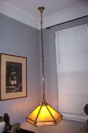 Hanging light figure of brass and slag glass