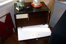 Table front opens to show storage and small drawer