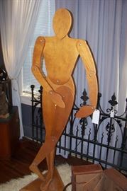 He frankly has scared us to death every time we entered the house!  Made of wood and is hinged to adopt many different poses.