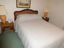 Queen bed with cane-back headboard