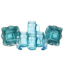 Assortment of Vintage Blue Glass: An assortment of vintage blue glass. The assortment includes four mason jar drinking cups, two boot shot glasses, and two candy dishes. The glass has a light blue color throughout collection. Unmarked.
