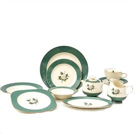 Fifty-Nine Piece Set of Century Service Corporation Semi Vitreous Dinnerware: A fifty-nine piece set of Century Service Corporation Semi Vitreous dinnerware. Included are five dinner plates, four square salad plates, ten bread plates, sixteen saucers, six cups, one creamer dish, one sugar bowl, six dessert bowls, one oval platter, and ten soup bowls. The white rose dishes have a green rim and green accents. Marking on each dish reads “Century Service Corporation, Semi Vitreous Dinnerware, Alliance Ohio, Emerald.”