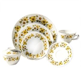 Thirty Piece Set of Noritake Cook'n Serve China in "Marguerite": A thirty piece set of Noritake Cook’n Serve china in the Marguerite. The Marguerite pattern features yellow and white flowers with green leaves. This set is marked on the bottom “Noritake, Cook n’ Serve, Japan China, 6730, Marguerite”. Included are four dinner plates, four salad plates, eight bread plates, nine saucers, four cups, and one sugar bowl.