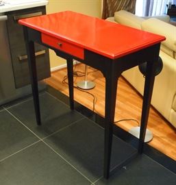 Lot 36: A Grange red and black writing table.  Or table à écrire, cherry with a red and black finish, having a rectangular top above a single drawer in the frieze, raised on square tapering legs.  A metal "Grange" label attached at the side and original paper label adhered under the drawer.  Ermitage Collection, ref. JU08M.  A few light scratches and minor nicks due to use; overall, good condition.  35 1/2 x 17 3/4 x 35" high.  ESTIMATE $300-500