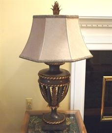 Lot 62: A Fine Art Lamps "Castille" table lamp with silk shade. Urn-form base with pierced feather motif, antiqued iron and gold leaf finish. Together with a hand sewn mocha brown silk shade. Both shade and lamp base are labeled "Fine Art Lamps". Item number 229710ST. Good condition. 38" high overall. ESTIMATE $100-200