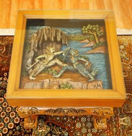 Lot 43: A pair of Indonesian carved and polychrome wood end tables. Square, each top uniquely carved in relief with figures in landscape settings, raised on four shaped legs with mask knees. Minor nicks and scuffs. With plate glass tops. 20 x 18 1/4" high. ESTIMATE $200-400