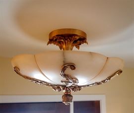Lot 64: A French style patinated metal and glass semi-flush ceiling fixture. Bronze finish with glass globe resembling alabaster. Good condition. 14 x 21" high. ESTIMATE $100-200