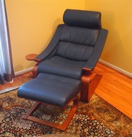 Lot 7: A Roche Bobois Royal Armchair and ottoman. Flexible lounge chair upholstered in dark blue Italian leather, with matching ottoman; each has a bent wood frame. Chair, 36" high. Good condition. ESTIMATE $ 1,000-2,000