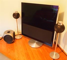 Lot 11: A Bang & Olufsen BeoVision 10-40 LCD TV, BeoLab Speakers & subwoofer, with attached Samsung Blue Ray DVD player. Measures 53" from corner to corner, with an attached Samsung Blue Ray DVD player. Label on television reads: Type #9573, Item #1846855, Serial #22078654. Together with 2 Bang & Olufsen BeoLab Speakers on stands(Item #1216511, Serial #23645354), and 1 BeoLab 2 subwoofer (Type #6863, Item #1680003, Serial #22671983). Good, used condition. ESTIMATE $2,000-3,000