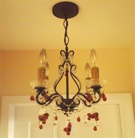 Lot 38: An Italian four-light chandelier. Patinated metal, hung with clear crystal bead swags and amber crystal drops. Good condition. 14" diameter, 16" high. ESTIMATE $300-500