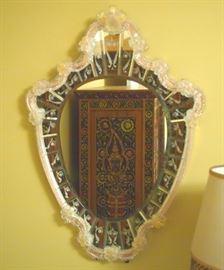 Lot 25: A Venetian etched glass mirror. Shield form frame with etched flowers and scrolls about, with applied moldings and flowers. Good condition. 23 x 32" high. ESTIMATE $600-800