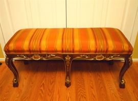 Lot 54: A French Regence style bench. Striped silk upholstery in autumnal tones, raised on modified cabriole legs. Mahogany finish with gilt accents. Light stains to the fabric; minor scuffs to the feet. 44 x 18" high. ESTIMATE $200-300
