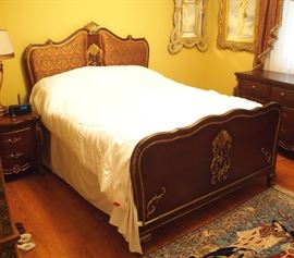 Lot 12: A French style mahogany and parcel gilt three-piece bedroom set. Comprising a queen-size headboard inset with silk fabric, English arts and crafts style, and truncated footboard; a dresser fitted with nine drawers; and a nightstand fitted with two drawers. Headboard, 61" high; dresser, 74 x 21 1/2 x 38" high. Minor indications of use. ESTIMATE $2,000-3,000