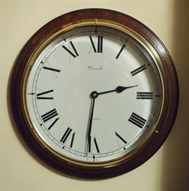 Lot 44: A contemporary English mahogany "The Bracket" wall clock by Comitti. Round with enameled dial, black Roman numerals. Battery operated. Model number B036.8. Good condition. 10 1/2" diameter. ESTIMATE $200-400