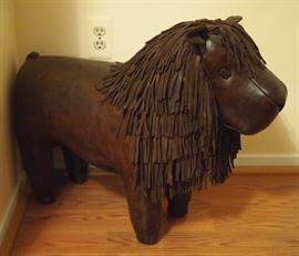 Lot 56: A contemporary Omersa leather lion footstool for Abercrombie & Fitch. Dark brown, with fringe mane and tail. Good condition. 22" high. ESTIMATE $200-300