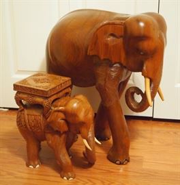 Lot 82: Two Indonesian carved wood elephants. The larger with damage to one toe and also light scratches. 15 and 26" high. ESTIMATE $100-200