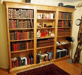 Lot 40: A contemporary walnut three-section bookcase. Beveled cornice above a total of twelve adjustable shelves. Minor scratches and evidence of use. 103 x 14 x 85" high. ESTIMATE $300-500