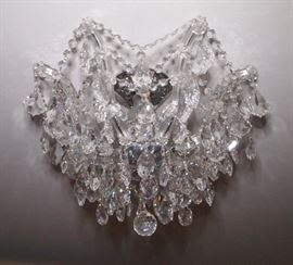 Lot 42: A crystal semi-flush mount ceiling fixture. Reminiscent of Schonbek, crystal arms hung with beaded swags and pendant drops. Approximately 16" diameter, 12" high. Good condition. ESTIMATE $300-500