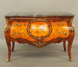 Lot 9: A contemporary Louis XV style commode.  Bombe shape in rosewood and kingwood with inlaid floral décor, fitted with two drawers, having cast bronze mounts, and surmounted by a conforming molded black marble top.  Minor wear.  50 x 22 x 36" high.  ESTIMATE $1,000-1,500